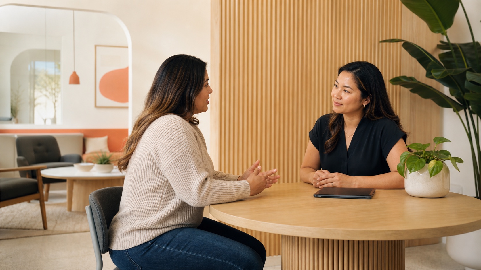 Patient discussing urinary symptoms with a clinician in a warm clinic setting